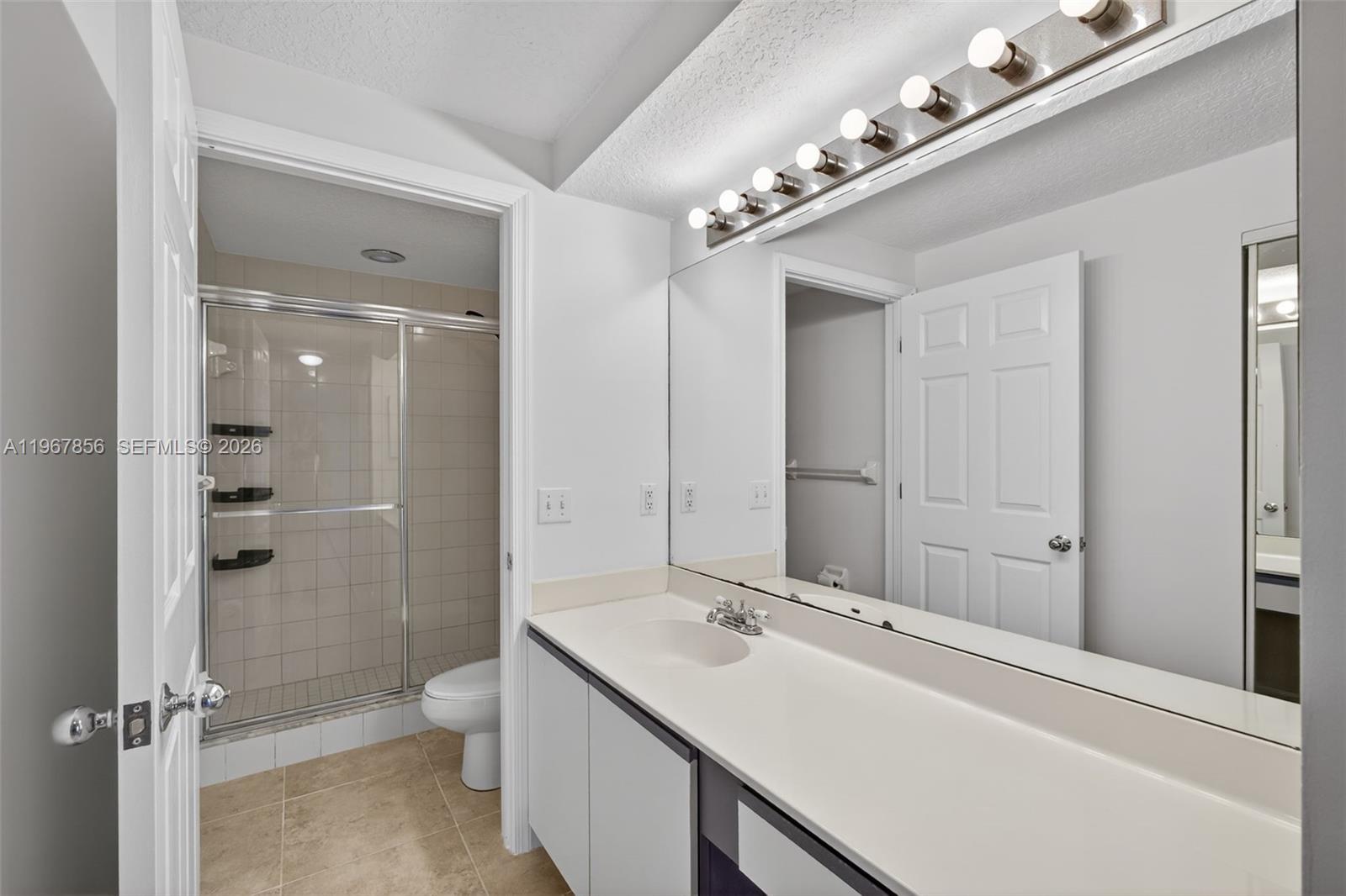 101 Muirfield Court, Unit 101D Jupiter, FL 33458 - Photo 19 of 62 a bathroom with a double vanity sink mirror and toilet
