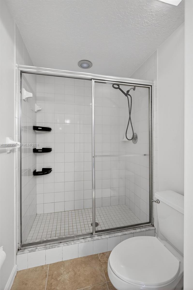 101 Muirfield Court, Unit 101D Jupiter, FL 33458 - Photo 23 of 62 a bathroom with a toilet and a shower