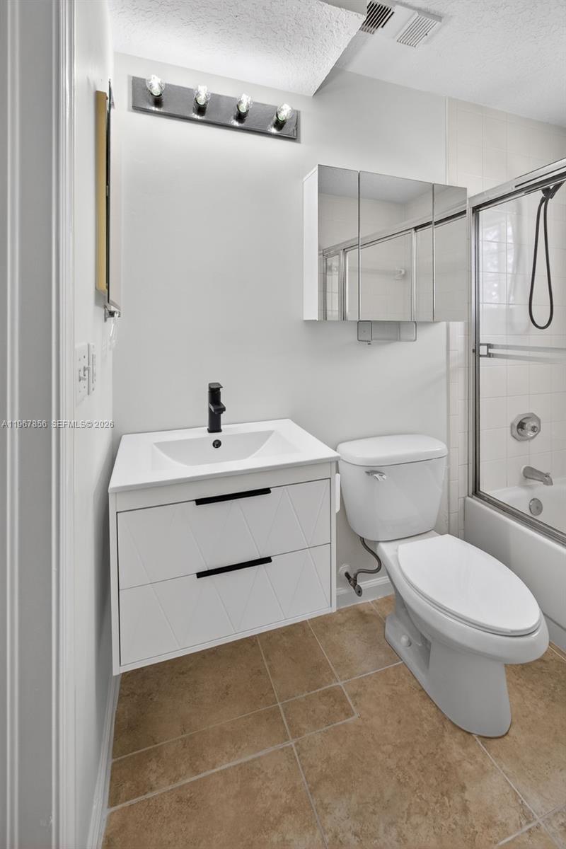 101 Muirfield Court, Unit 101D Jupiter, FL 33458 - Photo 26 of 62 a bathroom with a sink toilet vanity and shower