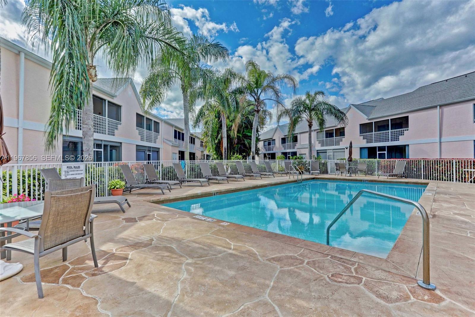 101 Muirfield Court, Unit 101D Jupiter, FL 33458 - Photo 42 of 62 a view of a swimming pool with a lounge chair