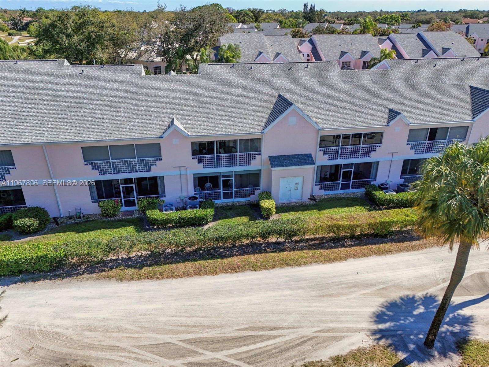101 Muirfield Court, Unit 101D Jupiter, FL 33458 - Photo 58 of 62 front view of a house with a yard