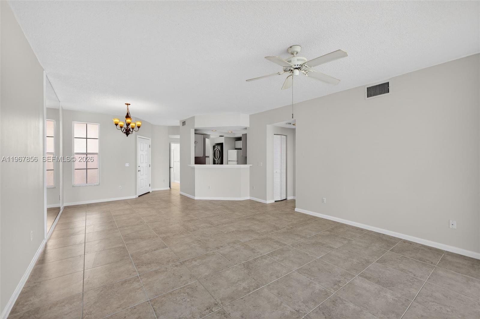 101 Muirfield Court, Unit 101D Jupiter, FL 33458 - Photo 8 of 62 a view of a livingroom with a ceiling fan and window