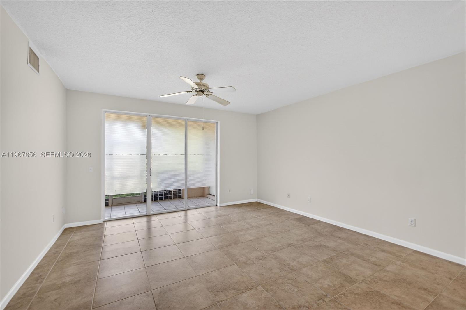 101 Muirfield Court, Unit 101D Jupiter, FL 33458 - Photo 10 of 62 wooden floor in an empty room with a window