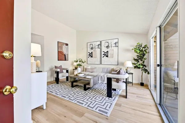 a living room with furniture and a potted plant