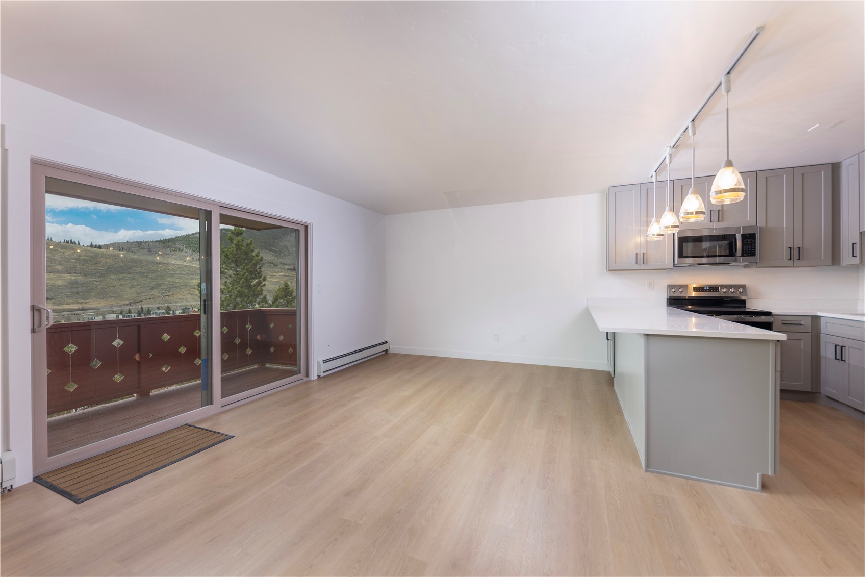 110 Evergreen Road, Unit 303 Dillon, CO 80435 - Photo 8 of 35 a view of a kitchen with a sink wooden cabinets and a window