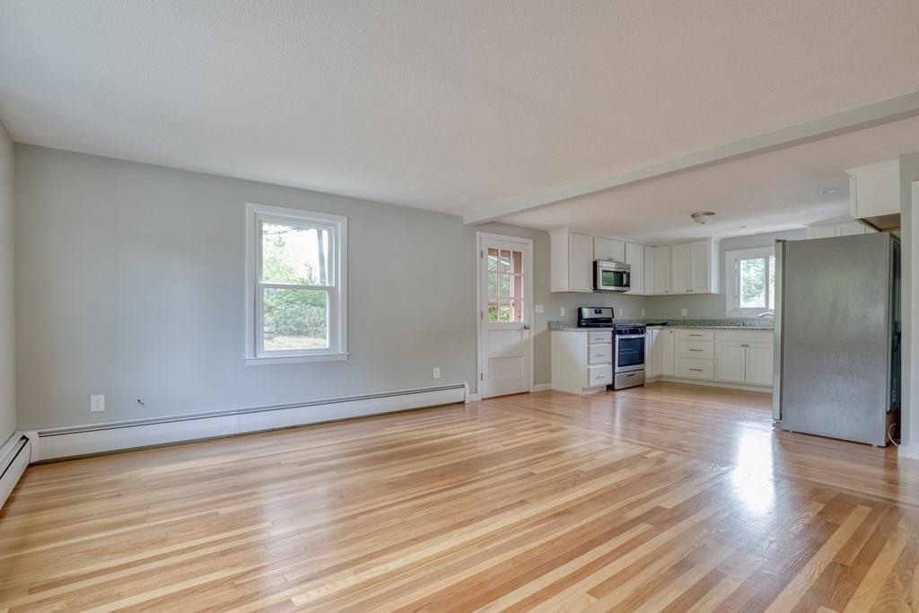 19 Knowlton Road Nashua, NH 03063 - Photo 14 of 35 a view of an empty room with wooden floor and a window