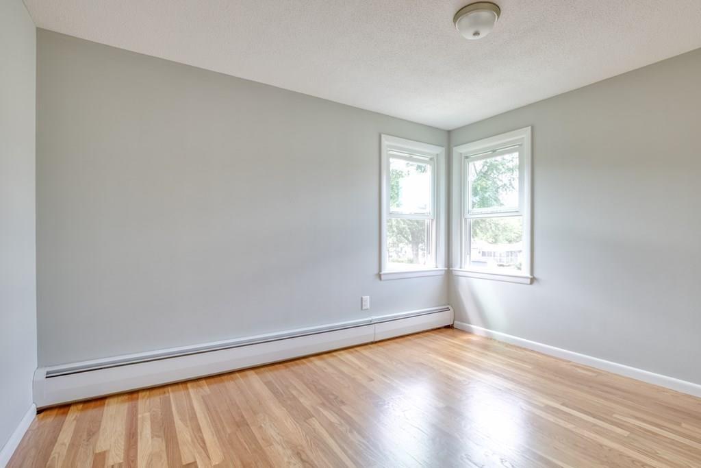 19 Knowlton Road Nashua, NH 03063 - Photo 20 of 35 an empty room with wooden floor and windows