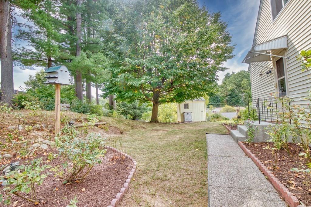 19 Knowlton Road Nashua, NH 03063 - Photo 32 of 35 a backyard of a house with table and chairs
