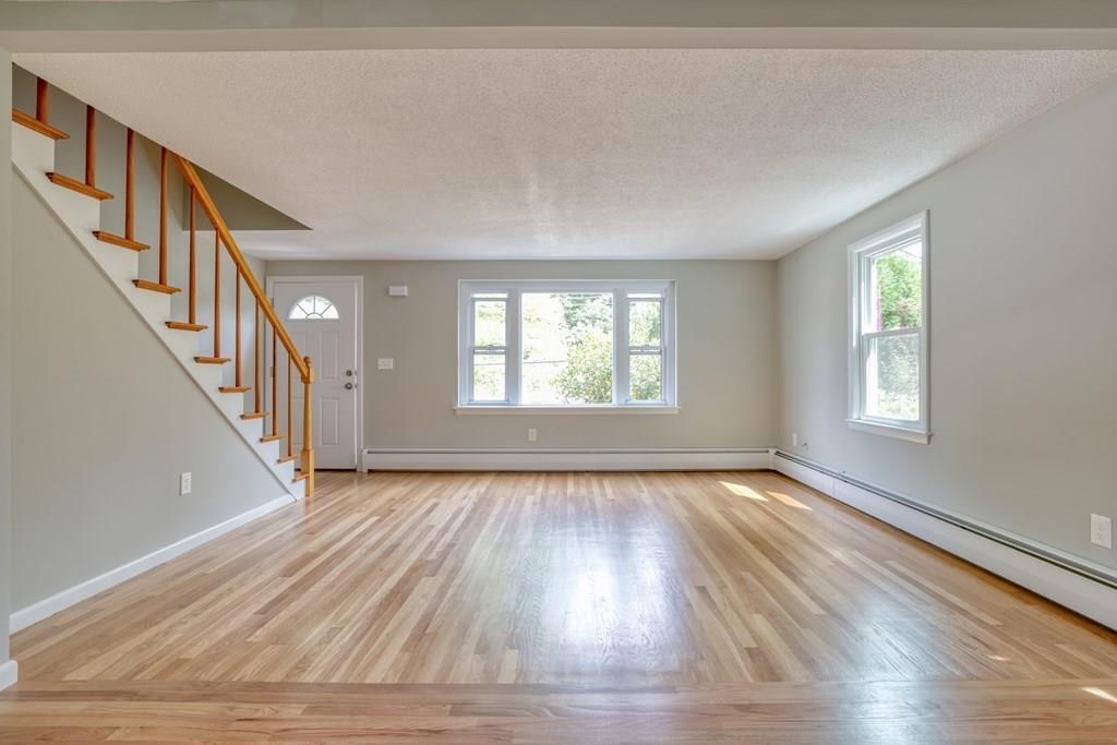 19 Knowlton Road Nashua, NH 03063 - Photo 5 of 35 a view of an empty room with wooden floor and a window