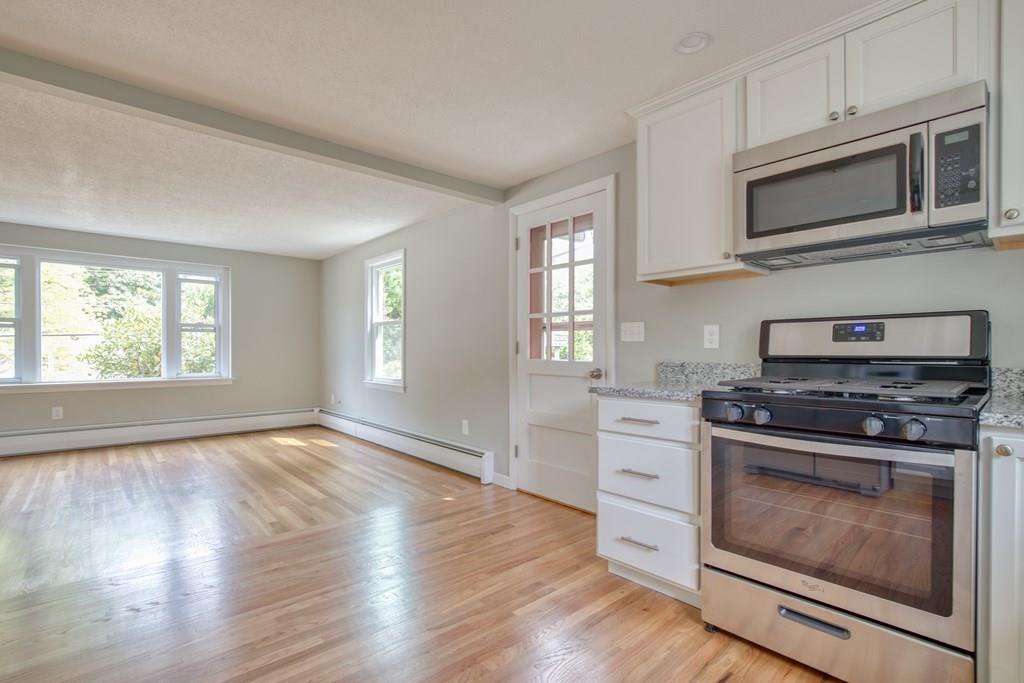 19 Knowlton Road Nashua, NH 03063 - Photo 8 of 35 a kitchen with a stove a microwave and window