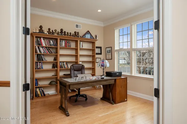 a view of a workspace with furniture and a window