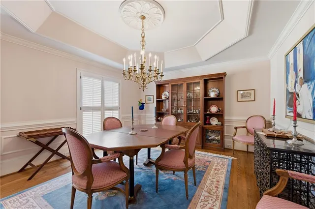 a view of a dining room with furniture and chandelier