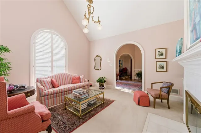 a living room with furniture fireplace and window