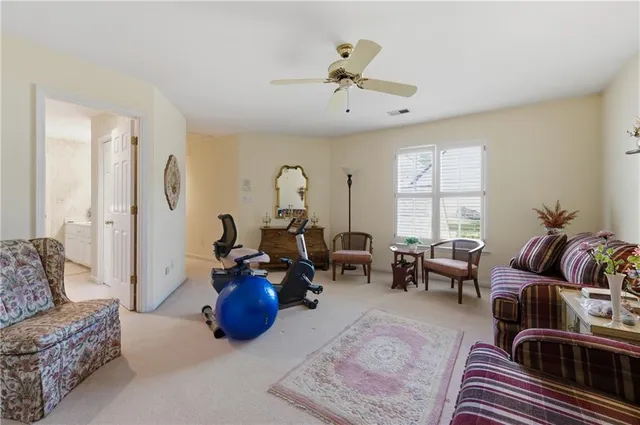 a living room with furniture a couch and a chandelier