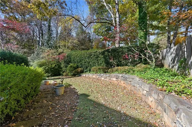 a lawn chair sitting in a yard with large trees