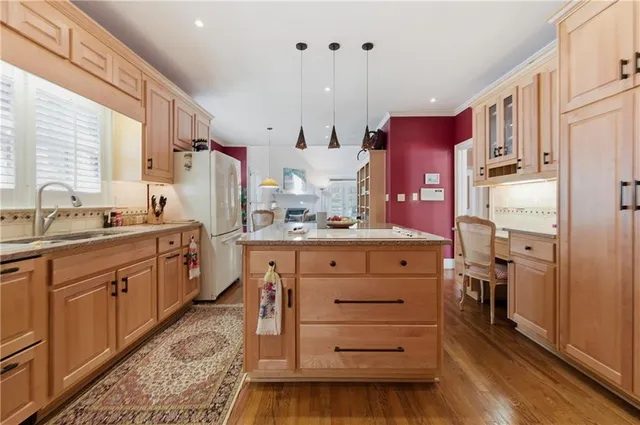 a kitchen with a sink stove and cabinets