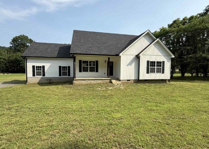 51 Bluff Creek Road Brush Creek, TN 38547 - Photo 1 of 23 a front view of a house with a garden