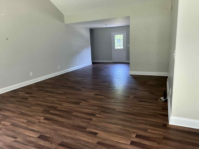 51 Bluff Creek Road Brush Creek, TN 38547 - Photo 10 of 23 wooden floor in a hall with an empty room