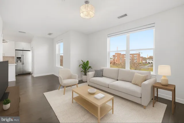 an empty room with wooden floor chandelier and windows