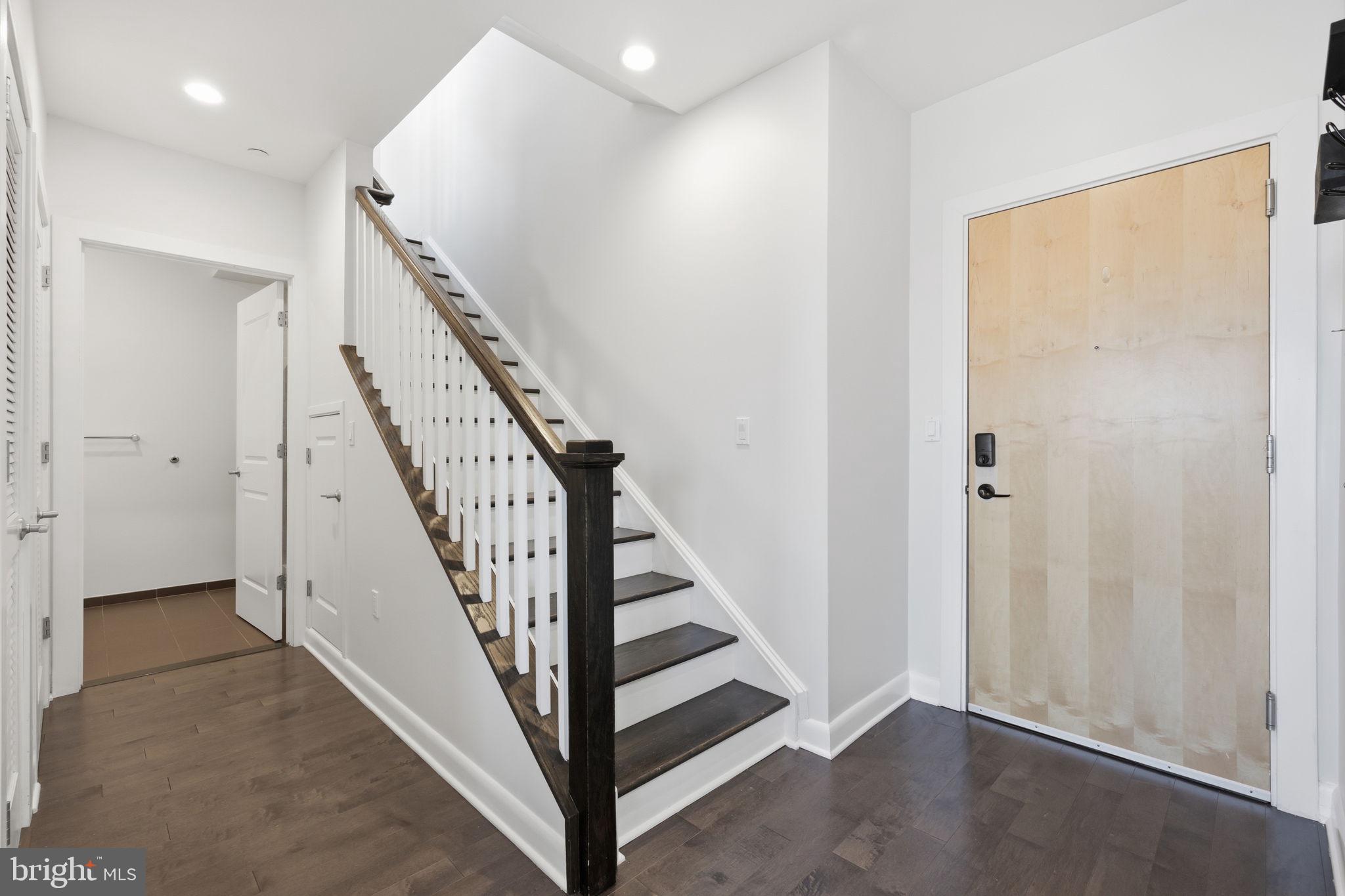 401 15th Street Southeast, Unit 401 Washington, DC 20003 - Photo 9 of 21 an entryway in a hallway with wooden floor and stairs