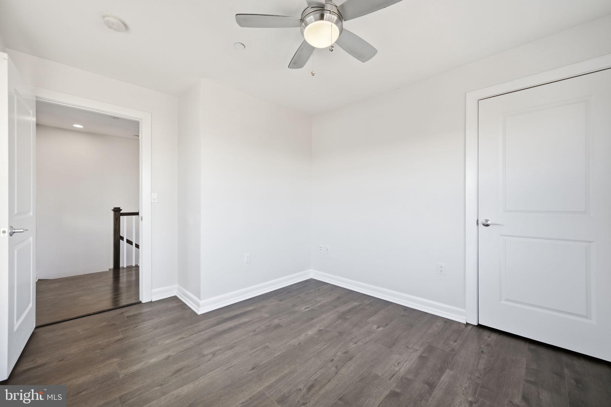 401 15th Street Southeast, Unit 401 Washington, DC 20003 - Photo 10 of 21 an empty room with wooden floor and ceiling fan