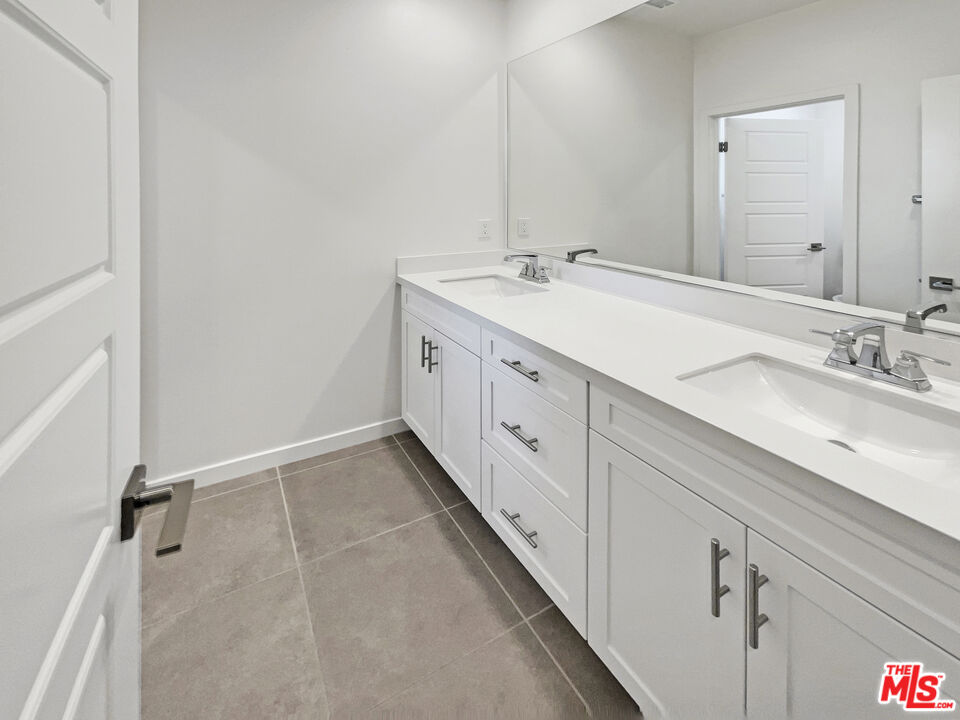 145 Stage Irvine, CA 92618 - Photo 14 of 20 a spacious bathroom with a double vanity sink and mirror