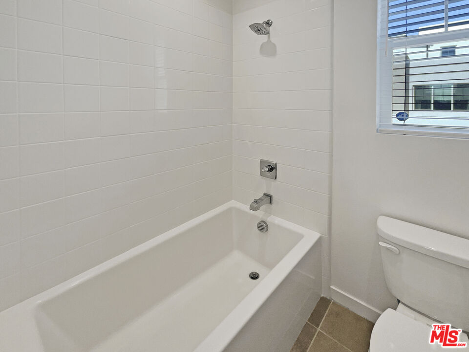 145 Stage Irvine, CA 92618 - Photo 15 of 20 a white bath tub sitting next to a toilet