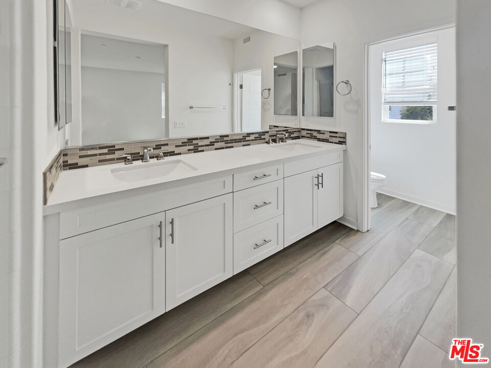 145 Stage Irvine, CA 92618 - Photo 17 of 20 a bathroom with a granite countertop sink and a mirror