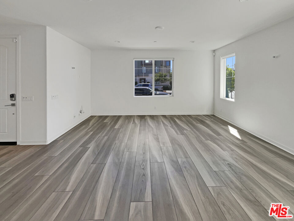 145 Stage Irvine, CA 92618 - Photo 3 of 20 a view of an empty room with wooden floor and a window