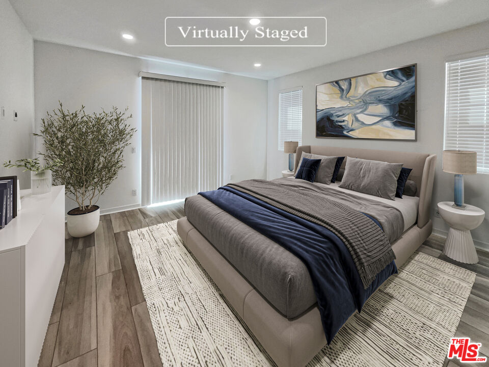 145 Stage Irvine, CA 92618 - Photo 4 of 20 a bedroom with a large bed and a painting on the wall