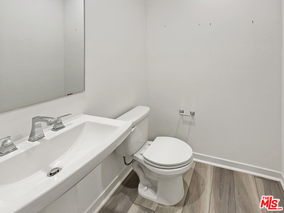 145 Stage Irvine, CA 92618 - Photo 8 of 20 a bathroom with a toilet sink and mirror