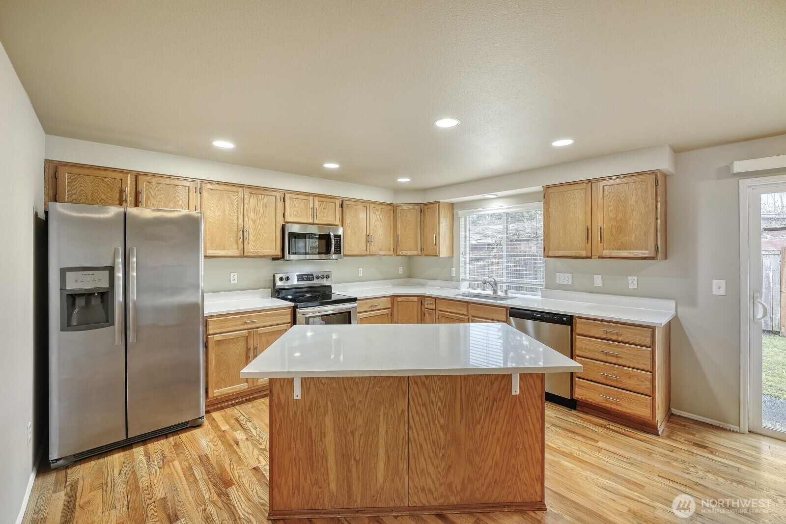 6740 Northeast 1st Place Renton, WA 98059 - Photo 3 of 21 a kitchen with stainless steel appliances granite countertop a refrigerator a sink and a stove