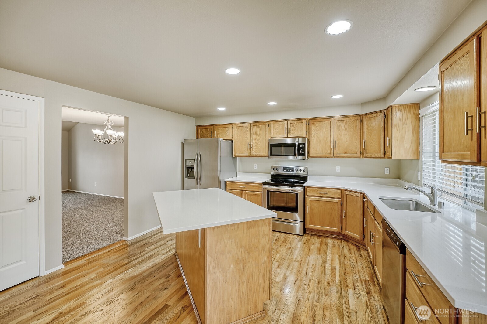 6740 Northeast 1st Place Renton, WA 98059 - Photo 4 of 21 a kitchen with stainless steel appliances granite countertop a sink refrigerator and cabinets