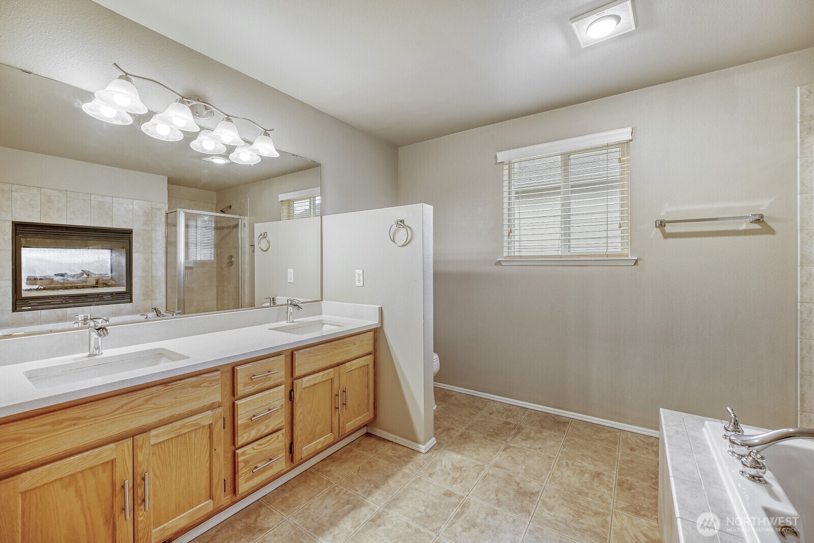 6740 Northeast 1st Place Renton, WA 98059 - Photo 6 of 21 a spacious bathroom with a sink a mirror and a shower