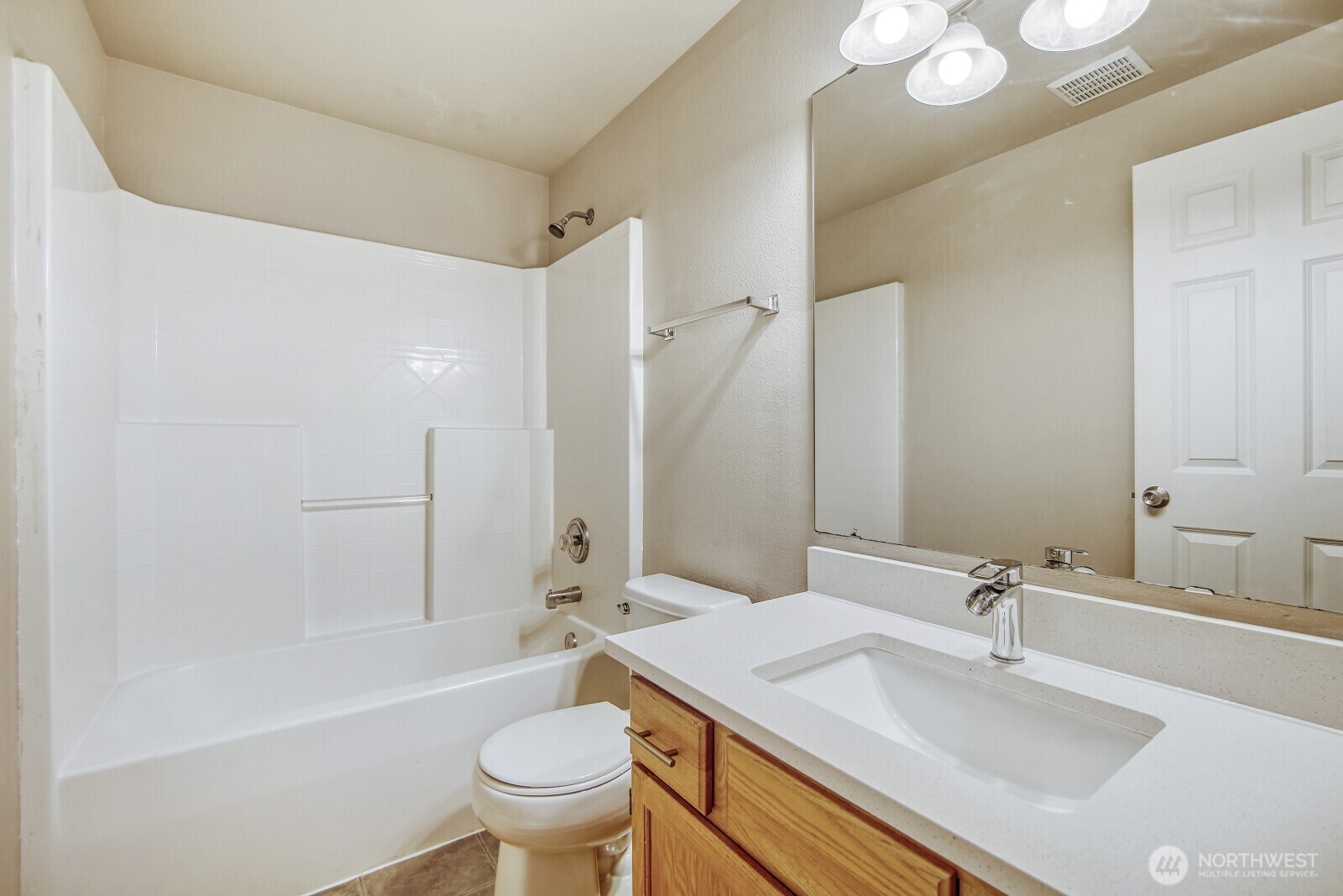 6740 Northeast 1st Place Renton, WA 98059 - Photo 8 of 21 a bathroom with a sink a toilet and a large mirror