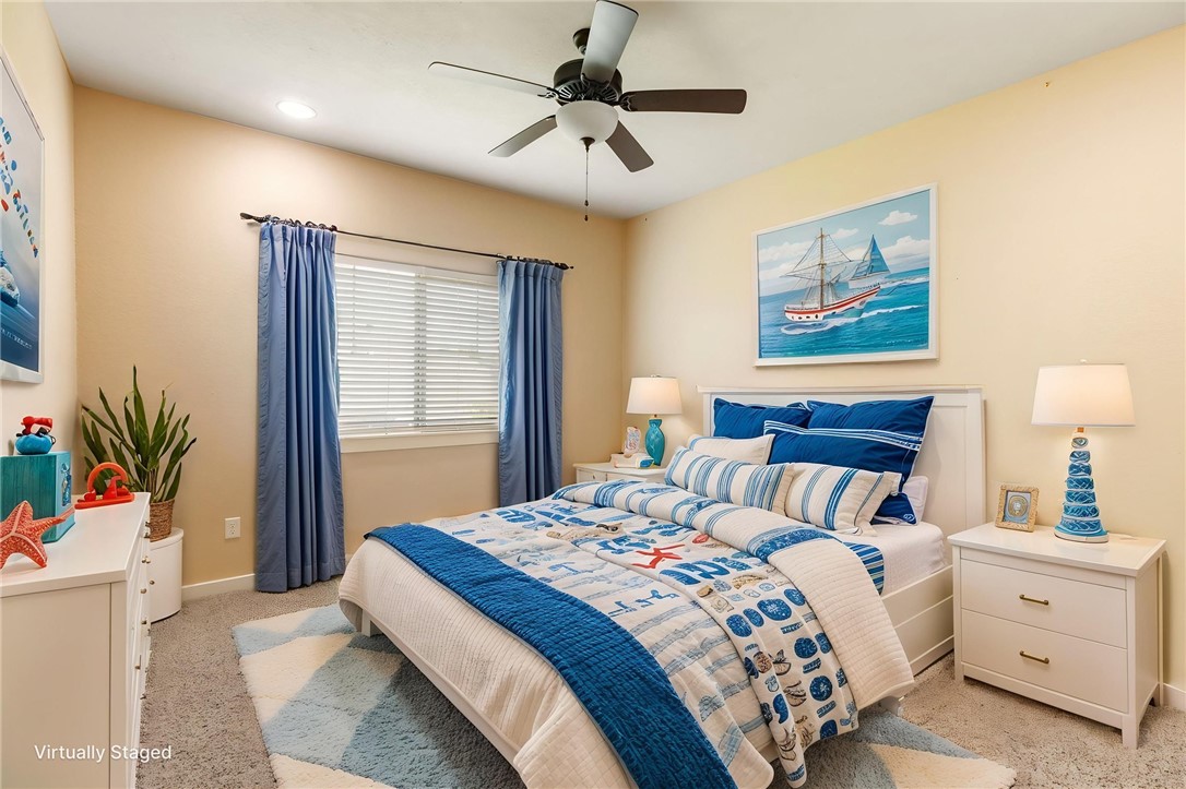 2136 Rockcliffe Loop College Station, TX 77845 - Photo 41 of 48 a bedroom with a large bed and a chandelier fan