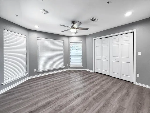 a large kitchen with stainless steel appliances granite countertop a lot of counter space and wooden floors