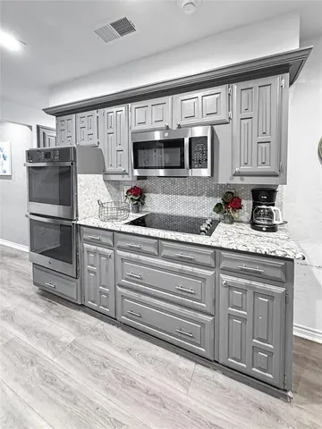 a kitchen with stainless steel appliances granite countertop a stove and a refrigerator