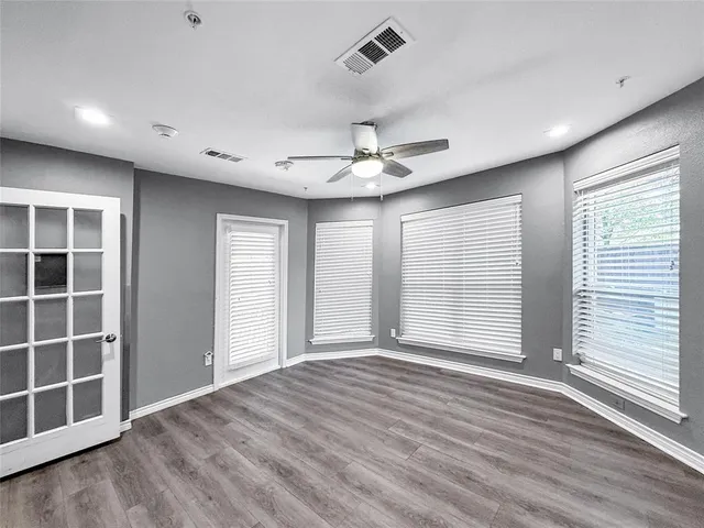 a view of a room with wooden floor and furniture