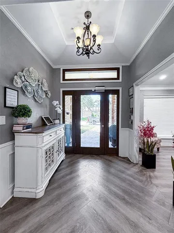 a view of a livingroom with furniture and a chandelier