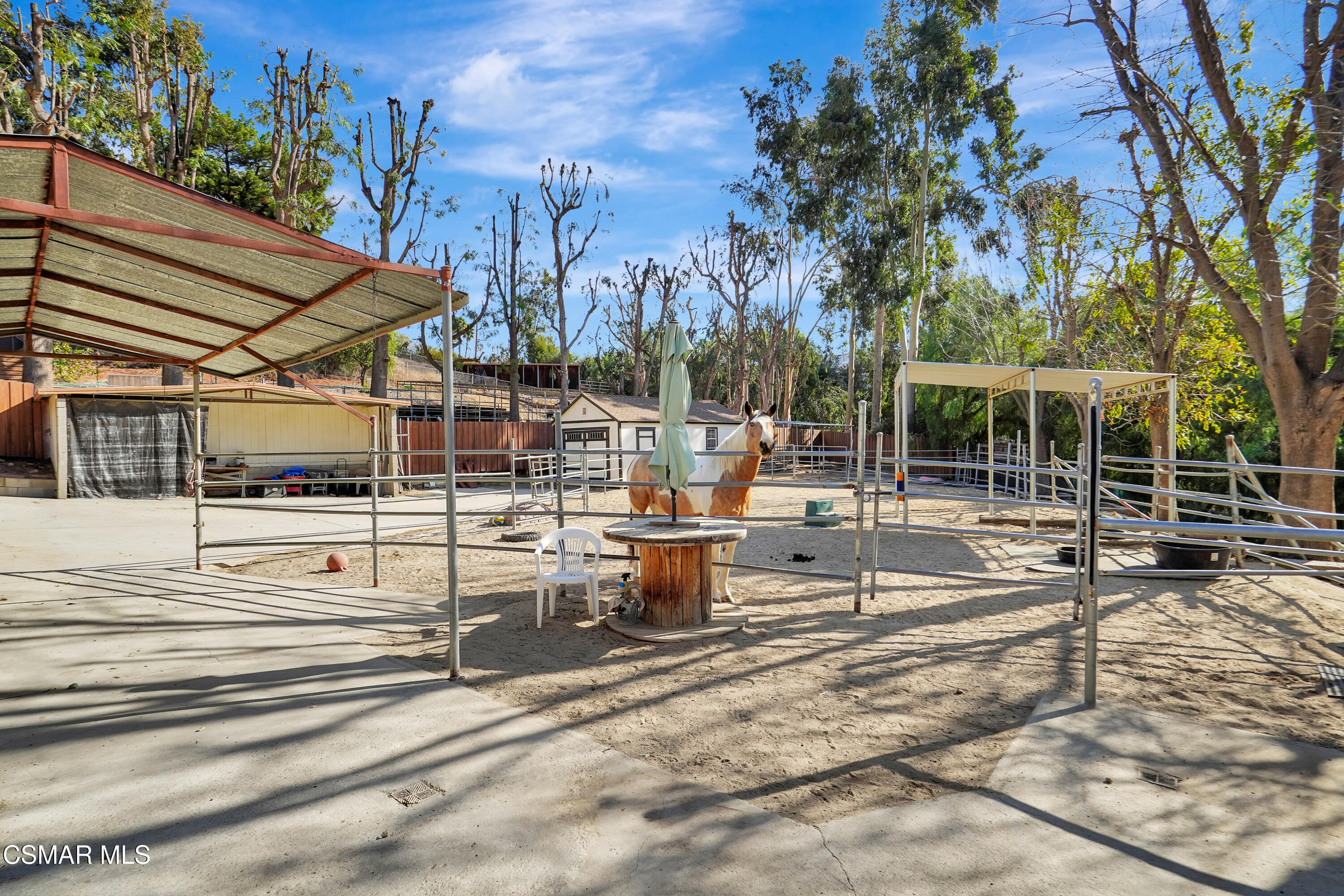 160 Wrangler Road Simi Valley, CA 93065 - Photo 55 of 65 a view of a patio with table and chairs next to yard with wooden fence