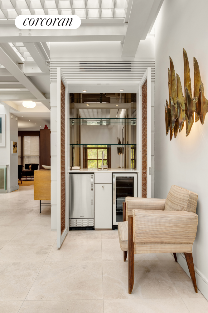 22 Gramercy Park South, Unit PH Manhattan, NY 10003 - Photo 3 of 25 a living room with furniture and a kitchen