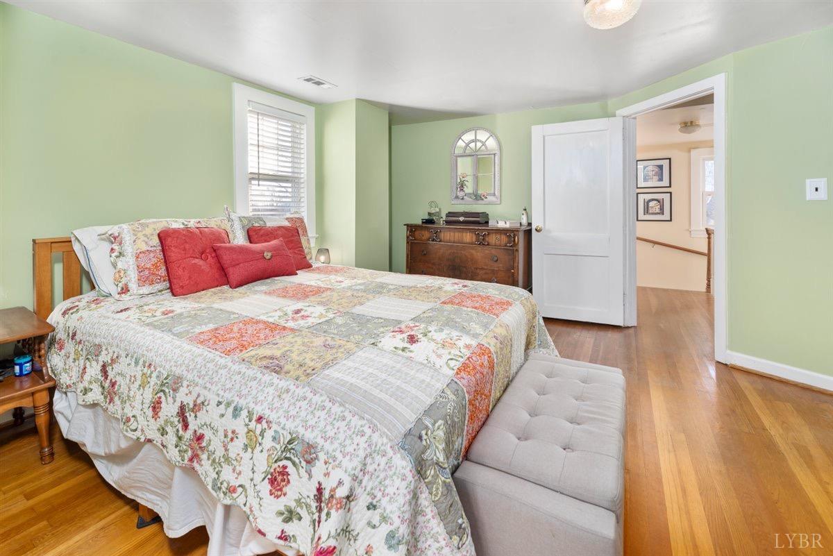 1045 Thrashers Creek Road Amherst, VA 24521 - Photo 21 of 54 a bedroom with a large bed and a dresser