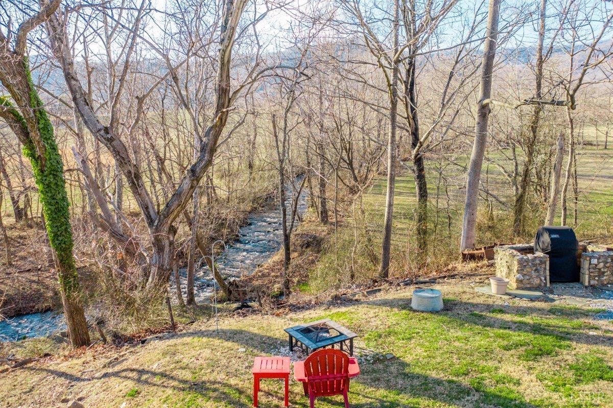 1045 Thrashers Creek Road Amherst, VA 24521 - Photo 30 of 54 a backyard of a house with table and chairs