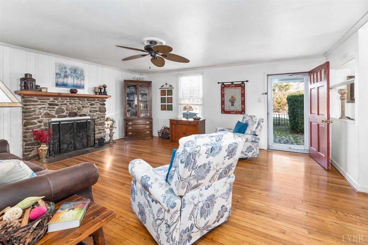 1045 Thrashers Creek Road Amherst, VA 24521 - Photo 5 of 54 a living room with furniture large window and a fireplace