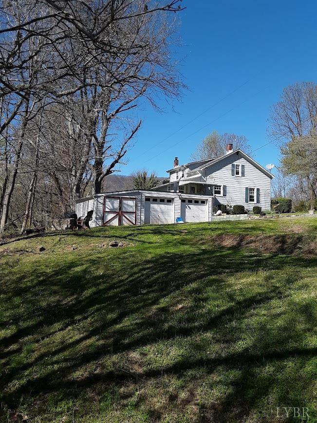 1045 Thrashers Creek Road Amherst, VA 24521 - Photo 54 of 54 a front view of a house with a garden