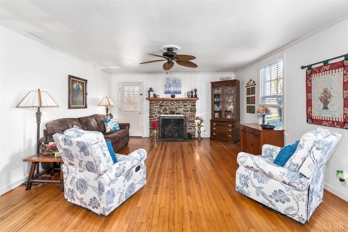 1045 Thrashers Creek Road Amherst, VA 24521 - Photo 6 of 54 a living room with furniture fireplace and wooden floor