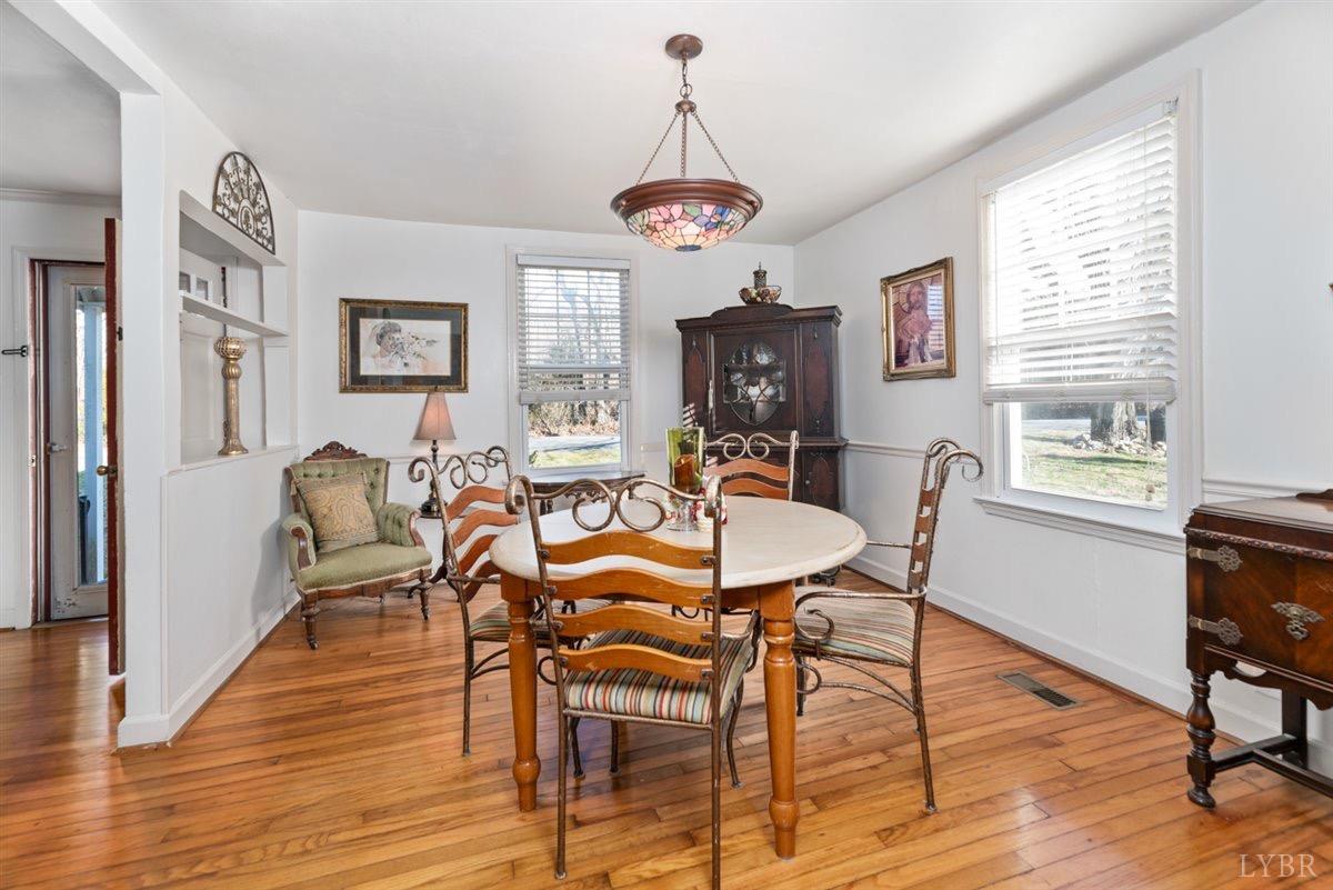 1045 Thrashers Creek Road Amherst, VA 24521 - Photo 7 of 54 a view of a dining room with furniture window and wooden floor