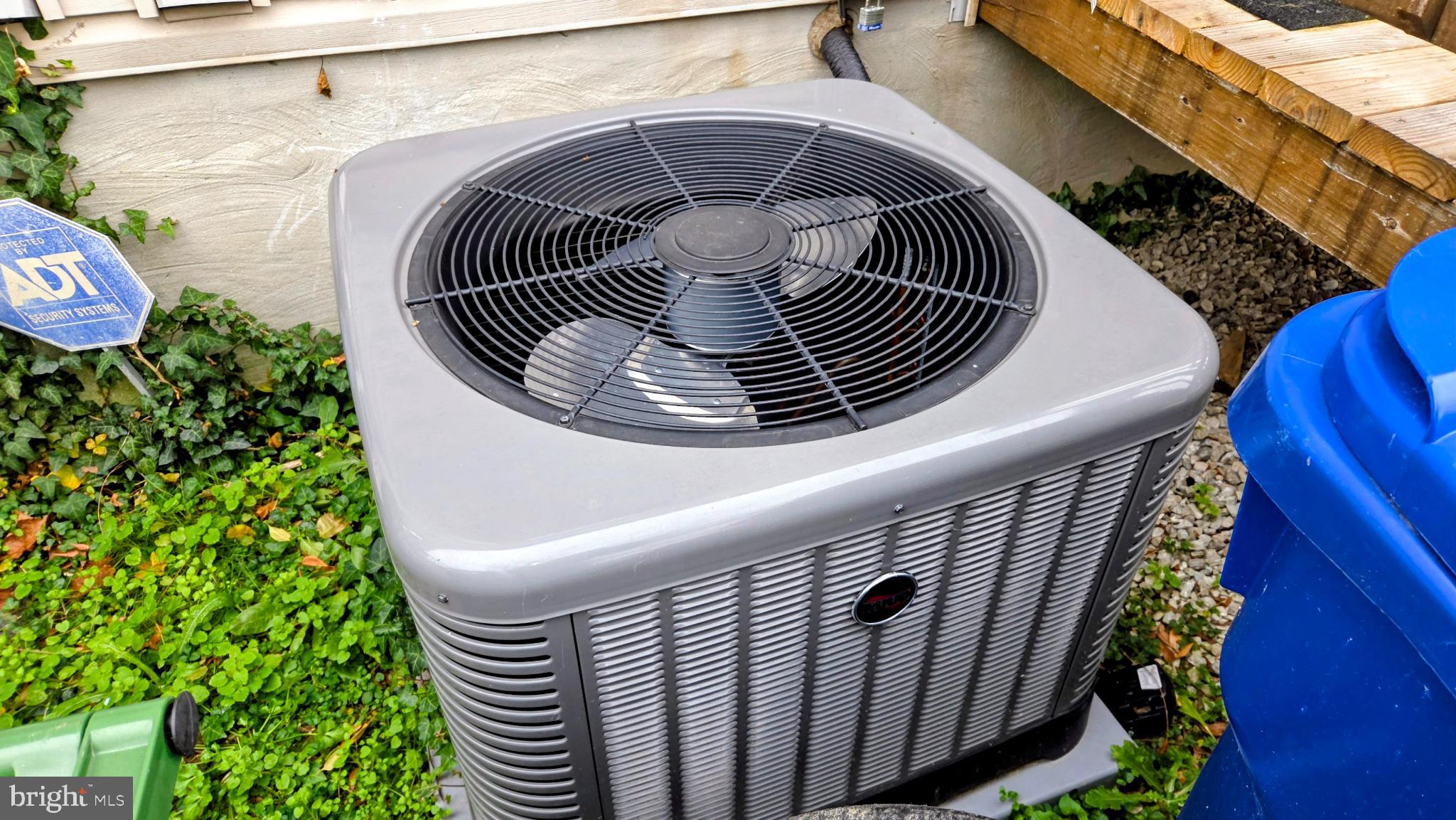 1226 East Chase Street Baltimore, MD 21202 - Photo 34 of 41 Efficient cooling unit nestled in greenery.