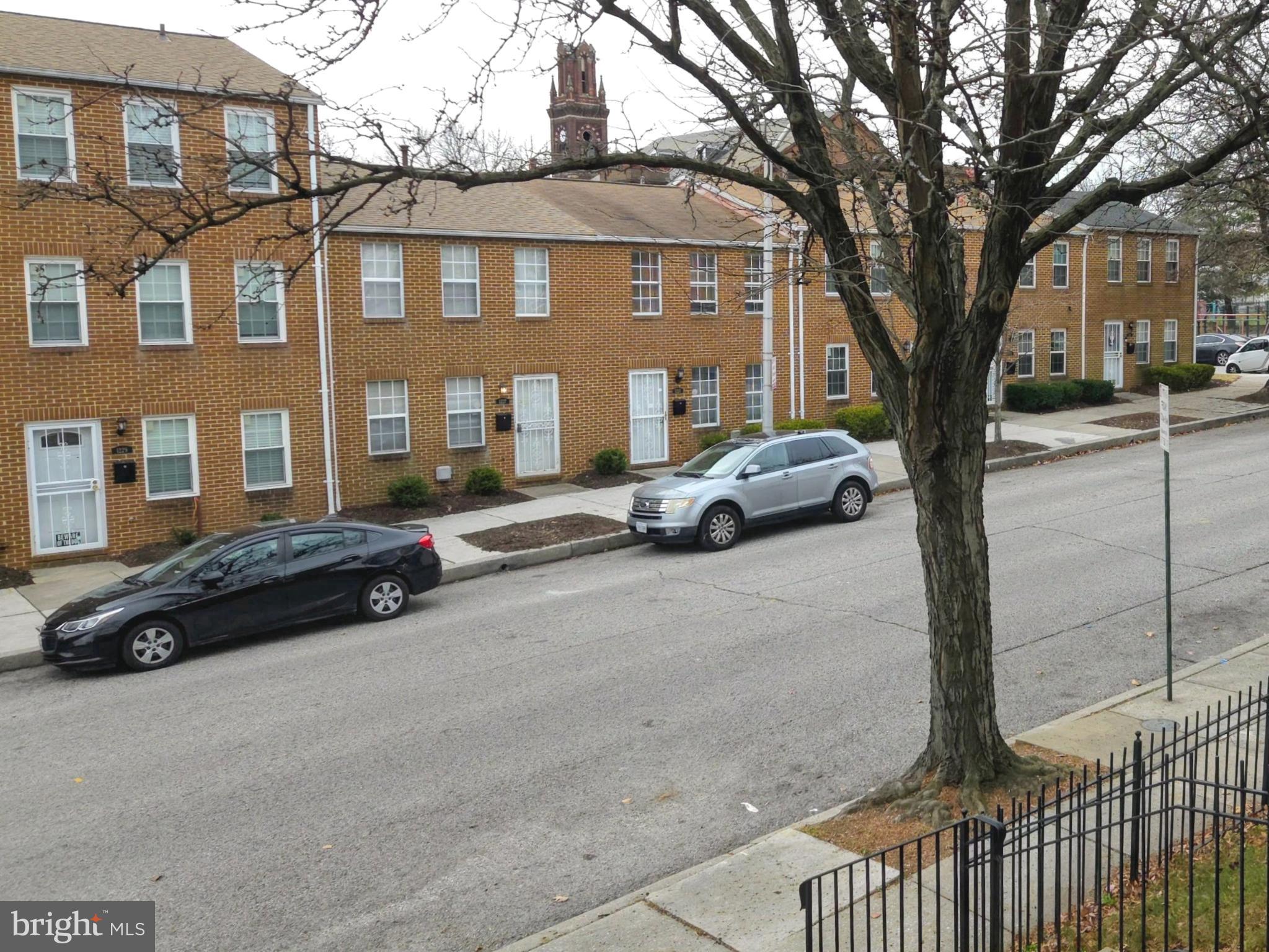1226 East Chase Street Baltimore, MD 21202 - Photo 40 of 41 Charming brick townhomes line a quiet street.